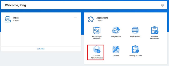 A screen capture of the Workday administrator home page/dashboard. The intro section sentence is Welcome, Ping and to the right has a gear icon. The page is split into two halves, the Inbox and Applications sections. The left or Inbox section contains a mail icon and the Inbox items. At the bottom center of this section is a Go to Inbox link. In the Applications or right section, is a puzzle icon. 7 icons and their corresponding application names are pictured. The Account Administration application of a person from the shoulders up with a gear icon is highlighted.